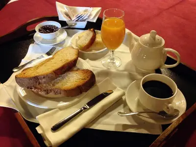 a table with a plate with a sandwich and a cup of coffee at La Hoja de Roble in Puebla de Sanabria