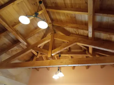 a ceiling in a room with wooden ceilings and lights at Casa la ti María la viuda in Riego de Lomba