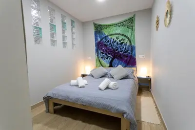 a bedroom with a bed with towels on it at La casa de Angel y Olimpia in Lugo