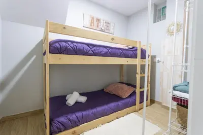 a bunk bed in a room with purple bunk beds at La casa de Angel y Olimpia in Lugo