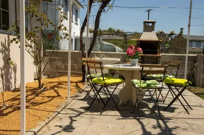 a patio with a table and chairs and a fireplace at La casa de Angel y Olimpia in Lugo