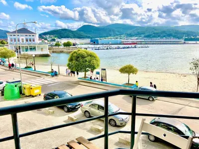 a view of a beach with cars parked in a parking lot at The Cliffs - Sunset Village Beach 1A in Viveiro