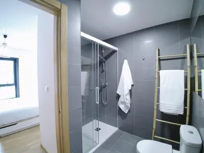 a bathroom with a shower and a toilet at The Cliffs - Sunset Village Beach 1A in Viveiro