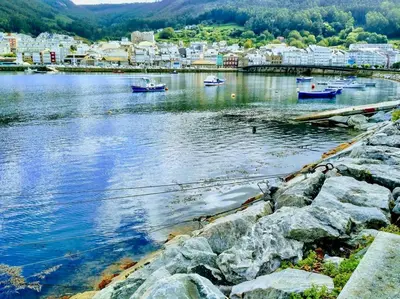 a large body of water with boats in it at The Cliffs - Sunset Village Beach 1A in Viveiro