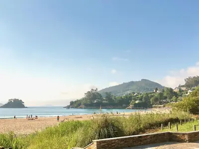 a view of a beach with people on it at The Cliffs - Sunset Village Beach 1C in Viveiro