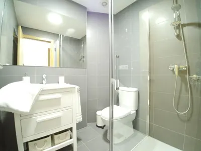 a bathroom with a shower and a toilet and a sink at The Cliffs - Sunset Village Beach 1C in Viveiro