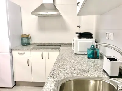 a kitchen with a sink and a microwave at The Cliffs - Sunset Village Beach 1D in Viveiro