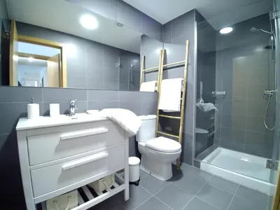 a bathroom with a sink and a toilet and a shower at The Cliffs - Sunset Village Beach 1D in Viveiro
