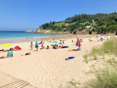 a group of people laying on a beach at The Cliffs - Sunset Village Beach 1D in Viveiro
