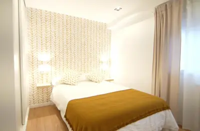 a bedroom with a bed in a room with a window at NOBE ROOMS in Santiago de Compostela