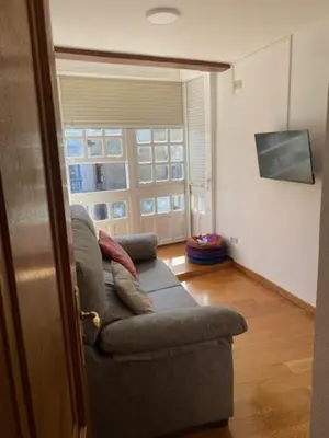 a living room with a couch and a window at entrepraciñas 1 in Santiago de Compostela