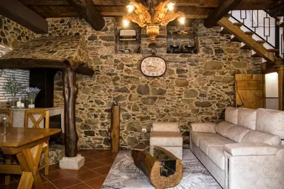 a living room with a couch and a clock on the wall at CASA PITAXAN in Melide