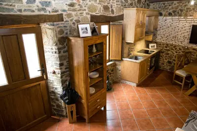 a kitchen with a wooden cabinet in a room at CASA PITAXAN in Melide