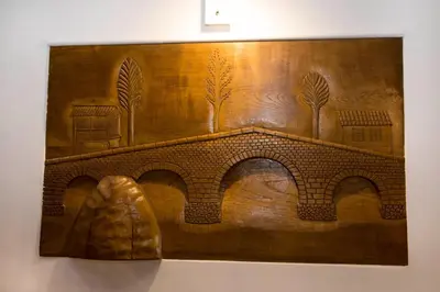 a wooden wall with a painting of a bridge at CASA PITAXAN in Melide