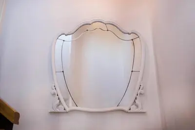 a mirror with a white frame on a wall at CASA PITAXAN in Melide