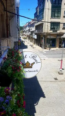 a sign with a dog on it on the side of a street at Apartamento Loft III Select Real Caldas de Reis in Caldas de Reis