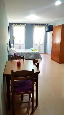 a room with a table and a bed and a bedroom at Apartamento Loft III Select Real Caldas de Reis in Caldas de Reis