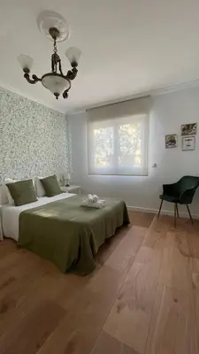 a bedroom with a large bed and a window at Falda do Pedroso in Santiago de Compostela
