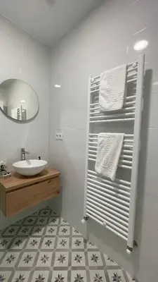 a bathroom with a white toilet and a sink at Falda do Pedroso in Santiago de Compostela