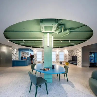 a lobby with a blue table and chairs at Loop INN Hostel Santiago de Compostela in Santiago de Compostela