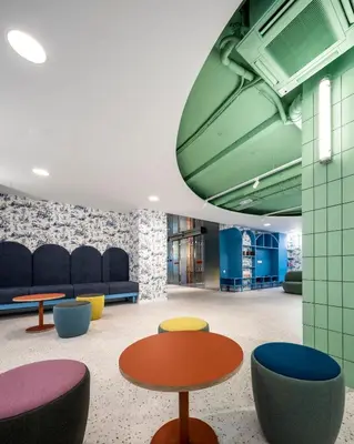 a lobby with colorful seating and tables and chairs at Loop INN Hostel Santiago de Compostela in Santiago de Compostela