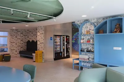 a waiting room with a table and chairs in a store at Loop INN Hostel Santiago de Compostela in Santiago de Compostela