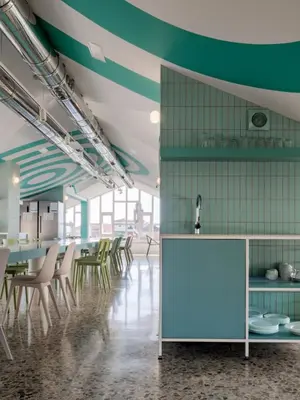 a room with chairs and a table and a counter at Loop INN Hostel Santiago de Compostela in Santiago de Compostela