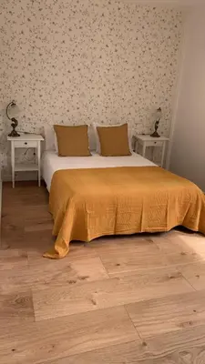 a bedroom with a bed with two tables and a wall at Campo de Estrellas in Santiago de Compostela