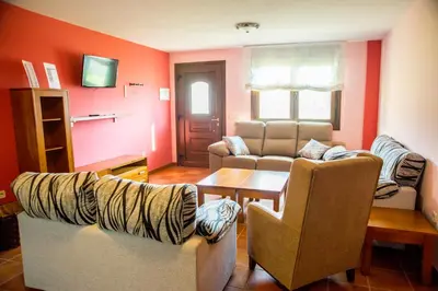 a living room with two chairs and a table at Welcome Villa Briallos in Portas