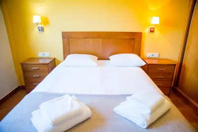 a bedroom with a bed with two towels on it at Welcome Villa Briallos in Portas