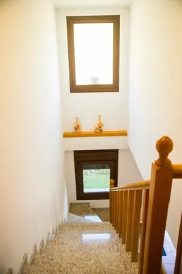 a stairway with a window and a window at Welcome Villa Briallos in Portas