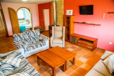 a living room with a couch and a table at Welcome Villa Briallos in Portas
