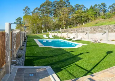 a backyard with a swimming pool and grass at Welcome Villa Briallos in Portas
