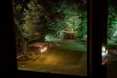 a view of a garden at night with lights at No-Mad Green Hotel in Molinaseca