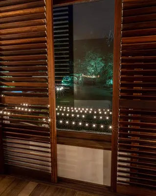 a window with christmas lights in a room at No-Mad Green Hotel in Molinaseca