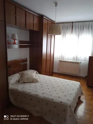 a bedroom with a bed and a large window at APARTAMENTO RAFER in Ribadeo