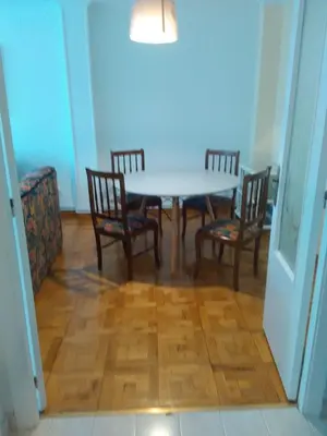 a dining room with a table and four chairs at APARTAMENTO RAFER in Ribadeo
