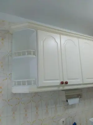 a kitchen with white cabinets in a bathroom at APARTAMENTO RAFER in Ribadeo