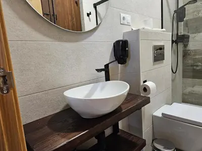 a bathroom with a bowl sink and a mirror at Apartamentos Rurales Lola Penarronda in Castropol