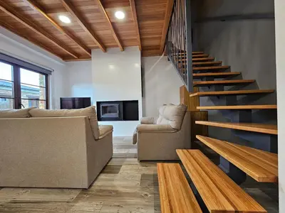 a living room with a couch and a staircase at Apartamentos Rurales Lola Penarronda in Castropol