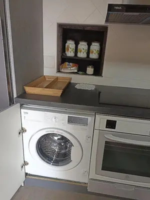 a kitchen with a washing machine and a counter at Finca Eiras in Lugo