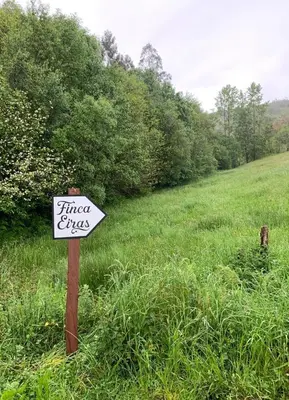 a sign that says first fires in a field at Finca Eiras in Lugo
