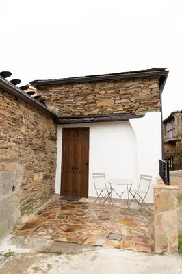a group of chairs sitting on the outside of a building at Finca Eiras in Lugo