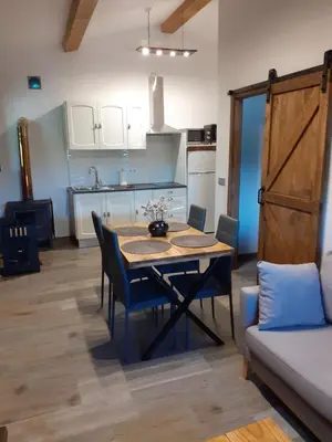 a kitchen and dining room with a table and chairs at A Nosa Casa 2 in Belesar