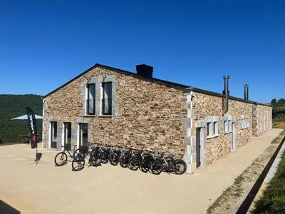 a group of bikes parked outside of a brick building at Casa Galego in Fonfría