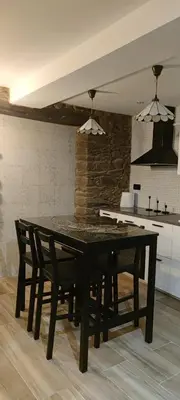 a black table and chairs in a kitchen at La Casita de Sofía in Monforte de Lemos