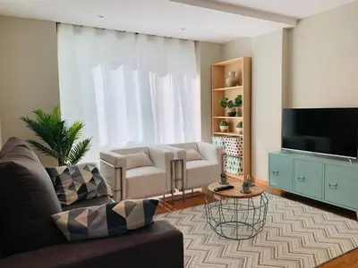 a living room with a couch and a tv at Viveiro Centro in Viveiro