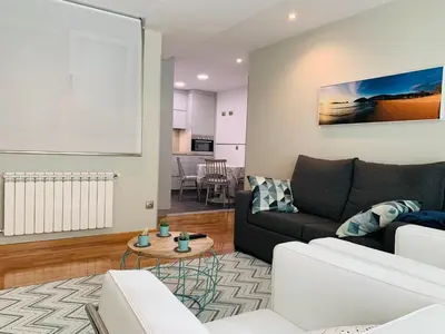 a living room with a couch and a table at Viveiro Centro in Viveiro