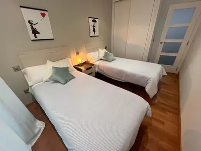 two beds in a room with white sheets at Viveiro Centro in Viveiro