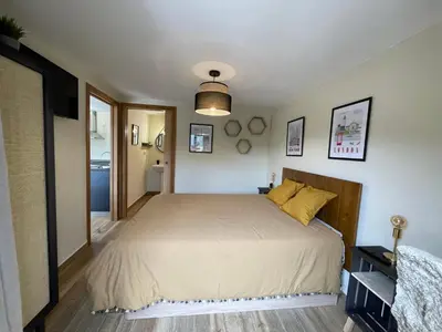 a bedroom with a large bed with yellow pillows at Ecolagar O Barqueiro in Pantón